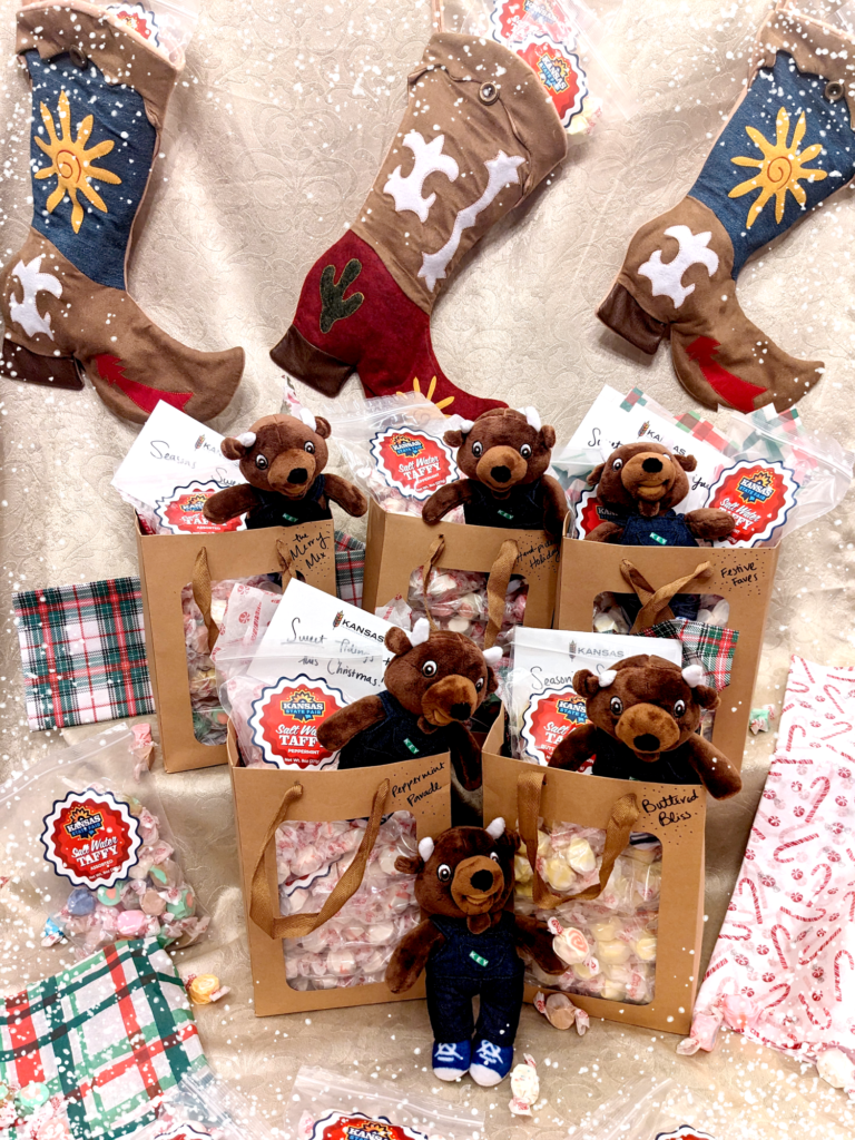 Holiday Taffy Packages in festive Christmas setting with stockings and presents